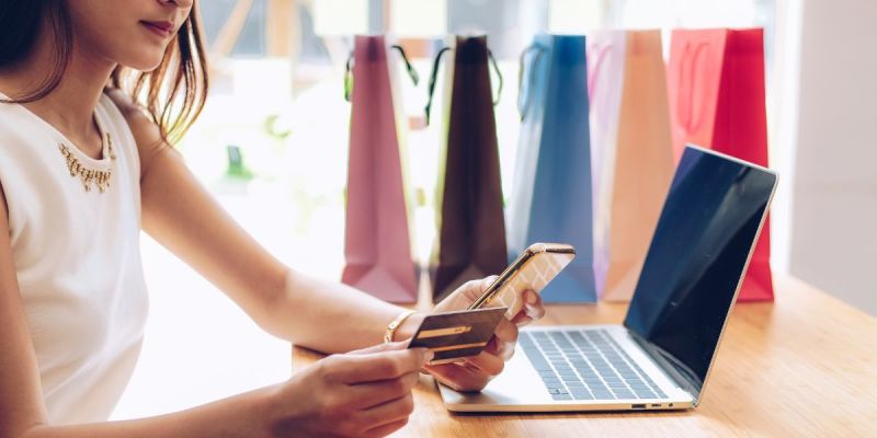 Woman shopping online with a credit card