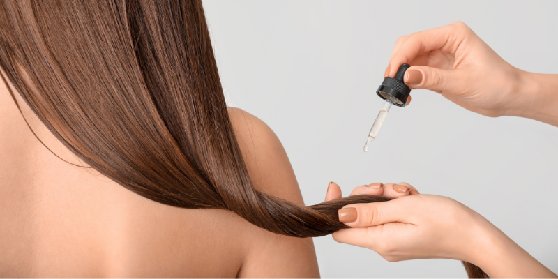 Applying product to woman's hair