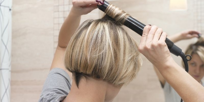 Woman curling hair